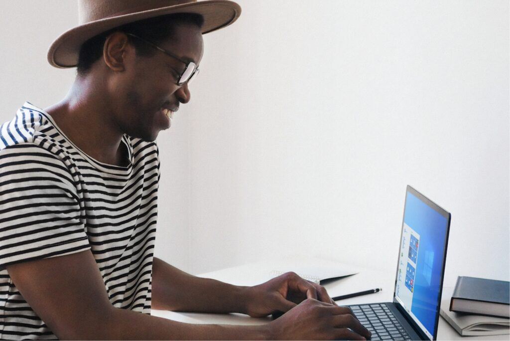 A man sits at a desk and works on his laptop